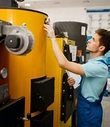 A man fixing a commercial boiler